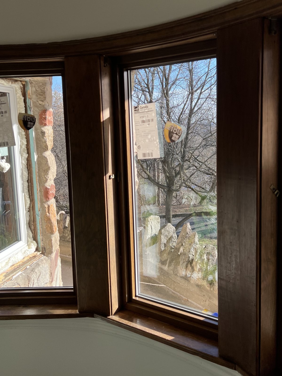 Interior view of a grouped window opening surrounded by warm wood trim
