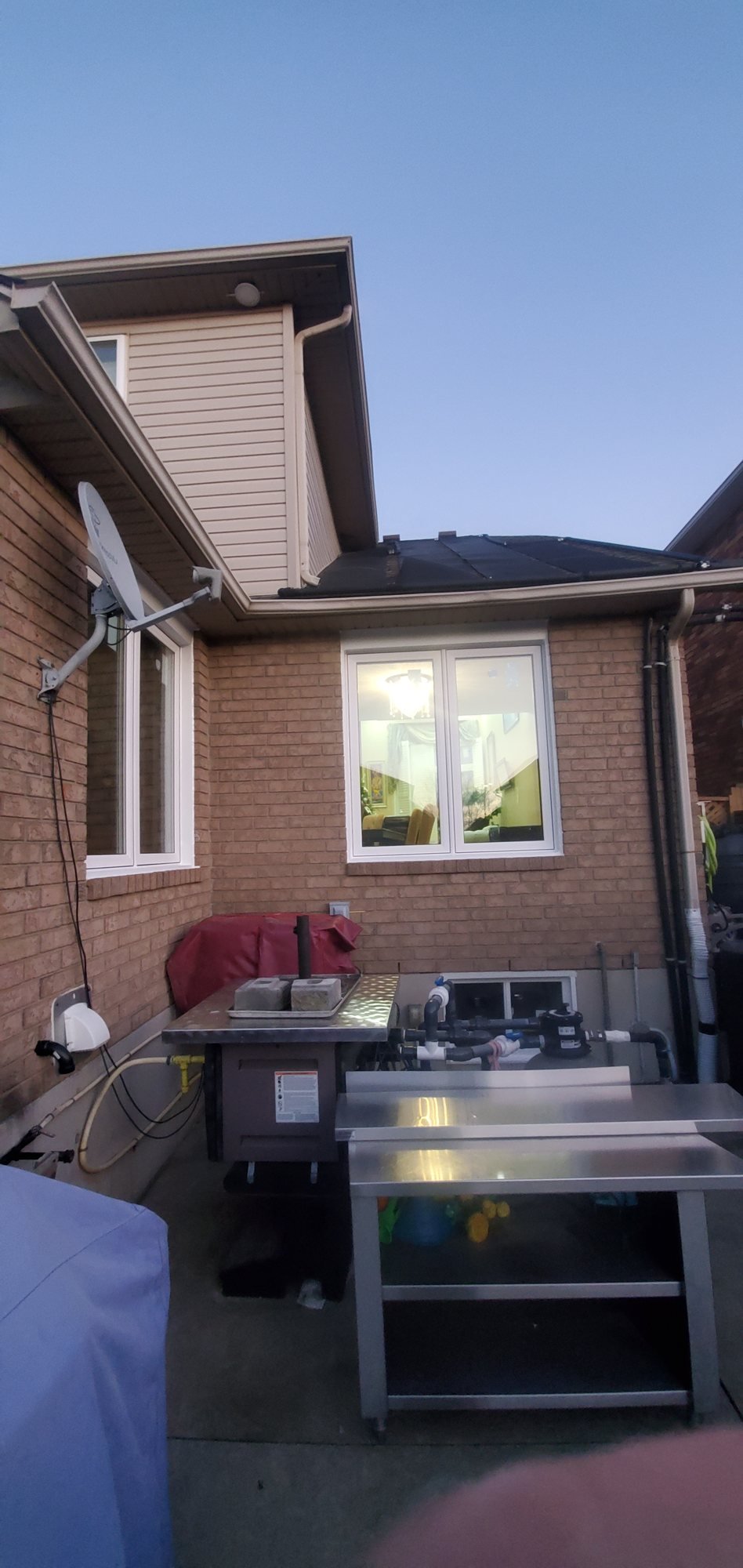 White casement replacement windows on the rear of a Stoney Creek brick home