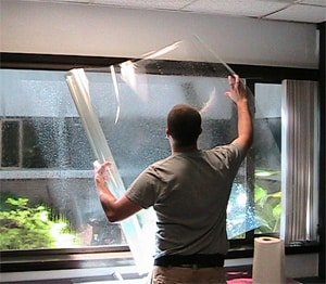 Installer applying architectural film to a large window