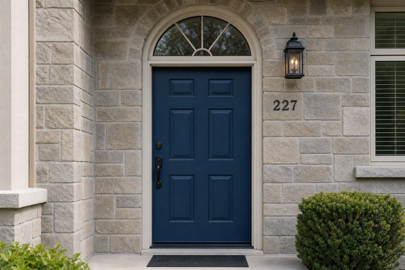Arched transom above a blue residential entry door